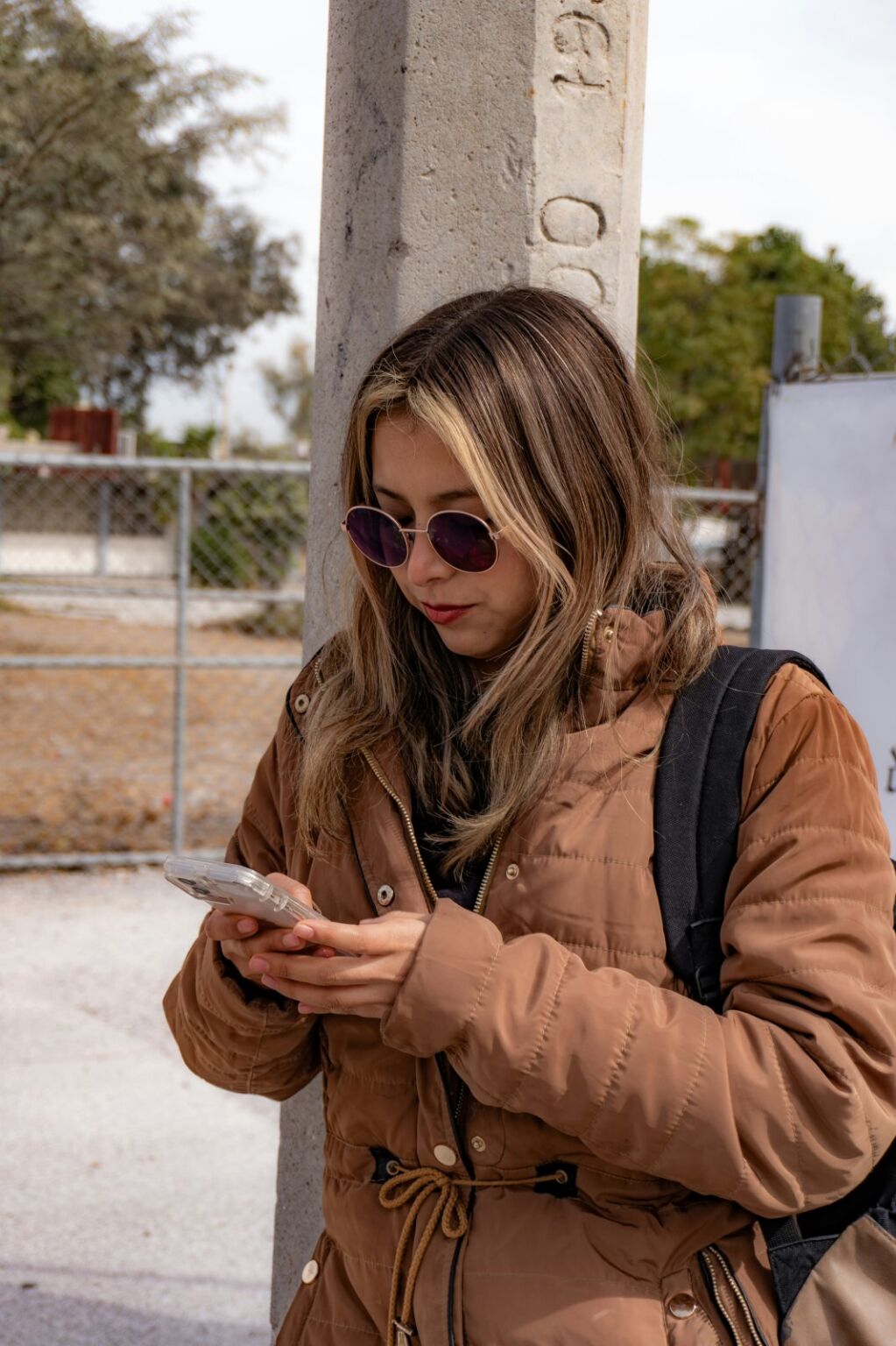 Woman with backpack checking her telephone.